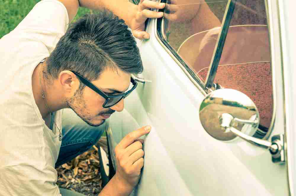 inspecting vintage car