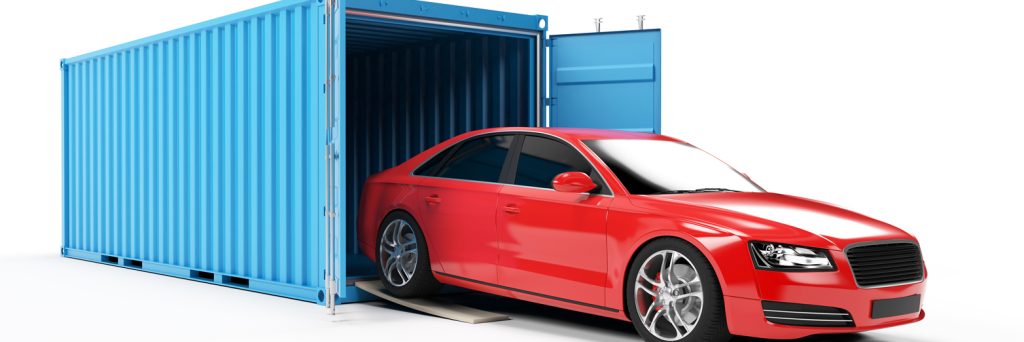 Photo of a car coming out of an enclosed shipping container.
