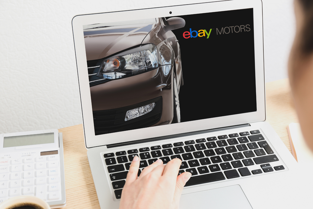photo of woman looking at a car for sale on eBay Motors
